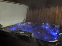 a jacuzzi tub with blue lights on it at Dépendance chaleureuse dans le vignoble nantais in La Haie-Fouassière