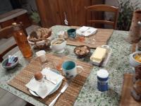 a table with food and drinks on top of it at Le Clos du Buisson in Saint-Julien-de-la-Liègue