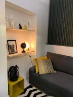 a living room with a couch and a lamp at SOO and CO SooHome in Marseille