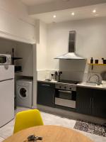 a kitchen with a sink and a stove top oven at SOO and CO SooHome in Marseille