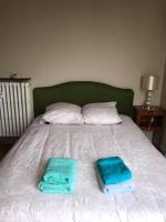 a bed with two towels on top of it at Suite Clémenceau 82 in Reims