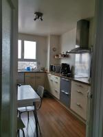 a small kitchen with a table and a table and a tableablish at Suite Clémenceau 82 in Reims