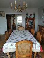 a dining room with a table and a chandelier at Suite Clémenceau 82 in Reims