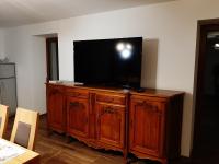 a wooden entertainment center with a flat screen tv on it at La Maison Trésallet in La Plagne Tarentaise