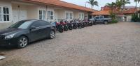 a row of motorcycles parked in front of a house at Hotel Nils in Itapoa