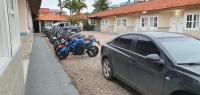 a car parked next to a row of motorcycles at Hotel Nils in Itapoa