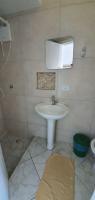a bathroom with a white sink and a mirror at Hotel Nils in Itapoa