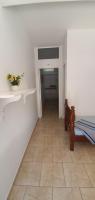 a hallway with a bed and a tile floor at Hotel Nils in Itapoa
