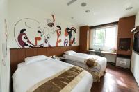 a hotel room with two beds and a mural on the wall at Shante Hotel Shitou in Lugu Lake