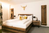 a bedroom with a large bed and a deer head on the wall at Sporthotel Igls in Innsbruck