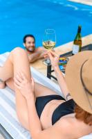 a woman holding a glass of wine next to a pool at Lares De Chacras in Chacras de Coria