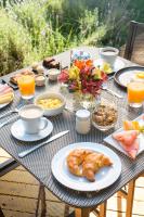 a table with breakfast foods and drinks on it at Lares De Chacras in Chacras de Coria