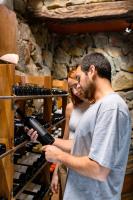 a man and a woman looking at a bottle of wine at Lares De Chacras in Chacras de Coria