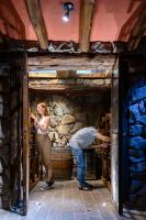a man and a woman standing in a wine cellar at Lares De Chacras in Chacras de Coria