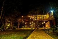 a building with a street light in front of it at night at Doola River Edge in Udawalawe