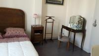 a bedroom with a bed and a mirror and a chair at L&#39;Ecrin in Villeneuve-sur-Lot