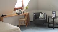 a bedroom with a desk and a chair and a laptop at Hotel Anlage Heidelberg in Heidelberg