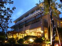 a building with lights in front of it at night at Zen and Pine Resort in Shuili