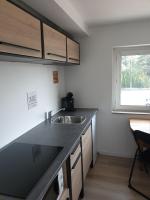 a small kitchen with a sink and a window at appartements T2 ou T3 idéalements situés in Brech