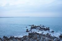 a group of people on a rocky beach in the water at HL Sea Homestay in Hualien City