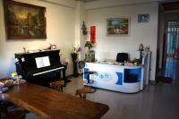a living room with a piano and a desk at HL Sea Homestay in Hualien City
