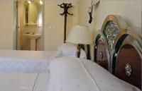 A bed or beds in a room at Hostal Delfina