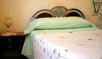 A bed or beds in a room at Hostal Delfina