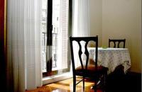 A bed or beds in a room at Hostal Delfina