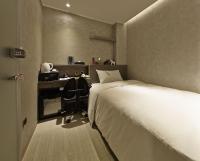 a hotel room with a bed and a desk at Beauty Hotels Taipei - Hotel B7 in Taipei