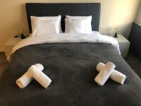 A bed or beds in a room at DISTRiCT 01-Luxury Urban Lofts