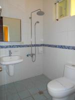 a bathroom with a toilet and a sink and a shower at Sansendai Sea View B&amp;B in Chenggong