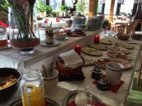 a table with many plates of food on it at Hotel Waldhaus in Bodenmais