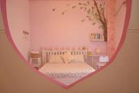 a bedroom with a bed in a heart shaped room at Happiness Factory in Huxi