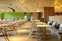 a dining room with wooden tables and chairs at Evergreen Palace Hotel Chiayi in Taibao