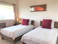 two beds sitting next to each other in a bedroom at Kenting COMIC B&amp;B in Hengchun South Gate