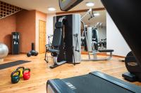 a gym with a treadmill and exercise equipment at Grand Hotel Zermatterhof in Zermatt
