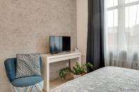 Televízia a/alebo spoločenská miestnosť v ubytovaní KATO Apartamenty Centrum