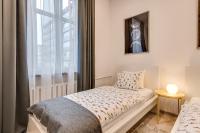 Posteľ alebo postele v izbe v ubytovaní KATO Apartamenty Centrum