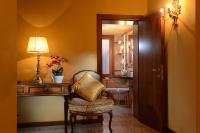 a hallway with a chair and a desk with a lamp at Antico Panada in Venice