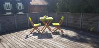 a table and two chairs on a deck at Dimai House No 15 Dornbirn Zentrum in Dornbirn