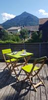 a green table and two chairs on a deck at Dimai House No 15 Dornbirn Zentrum in Dornbirn
