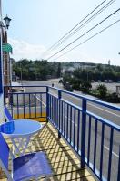 a table and chairs on a balcony with a view of a street at Nandian Homestay in Eluan