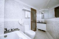 a white bathroom with a toilet and a sink at Guide Hotel Taipei Xinyi in Taipei