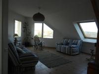 a living room with two couches and a rug at VILLA THEDIEBERT in Barneville-Carteret