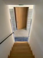 a hallway with a wooden door and a staircase at Hotelski in Verbier
