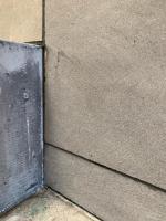 a corner of a brick wall with a metal door at Hotelski in Verbier
