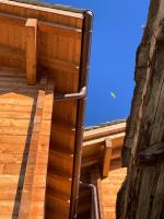 a ladder in a wooden building with a window at Hotelski in Verbier