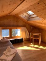 a room with a bed and a table in a attic at Hotelski in Verbier