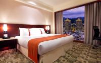 a hotel room with a large bed and a large window at HiONE Holiday Hotel in Shenkeng