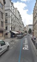 a city street with a white car parked on the road at Rue François Miron in Paris